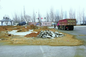 路口水泥路旁堆满黄土