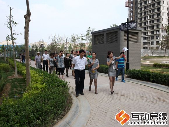 图为置业顾问引领客户们参观国宅景观