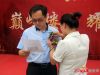 工作人员为河北卓冠房地产开发有限公司常务副总杨磊先生佩戴胸花